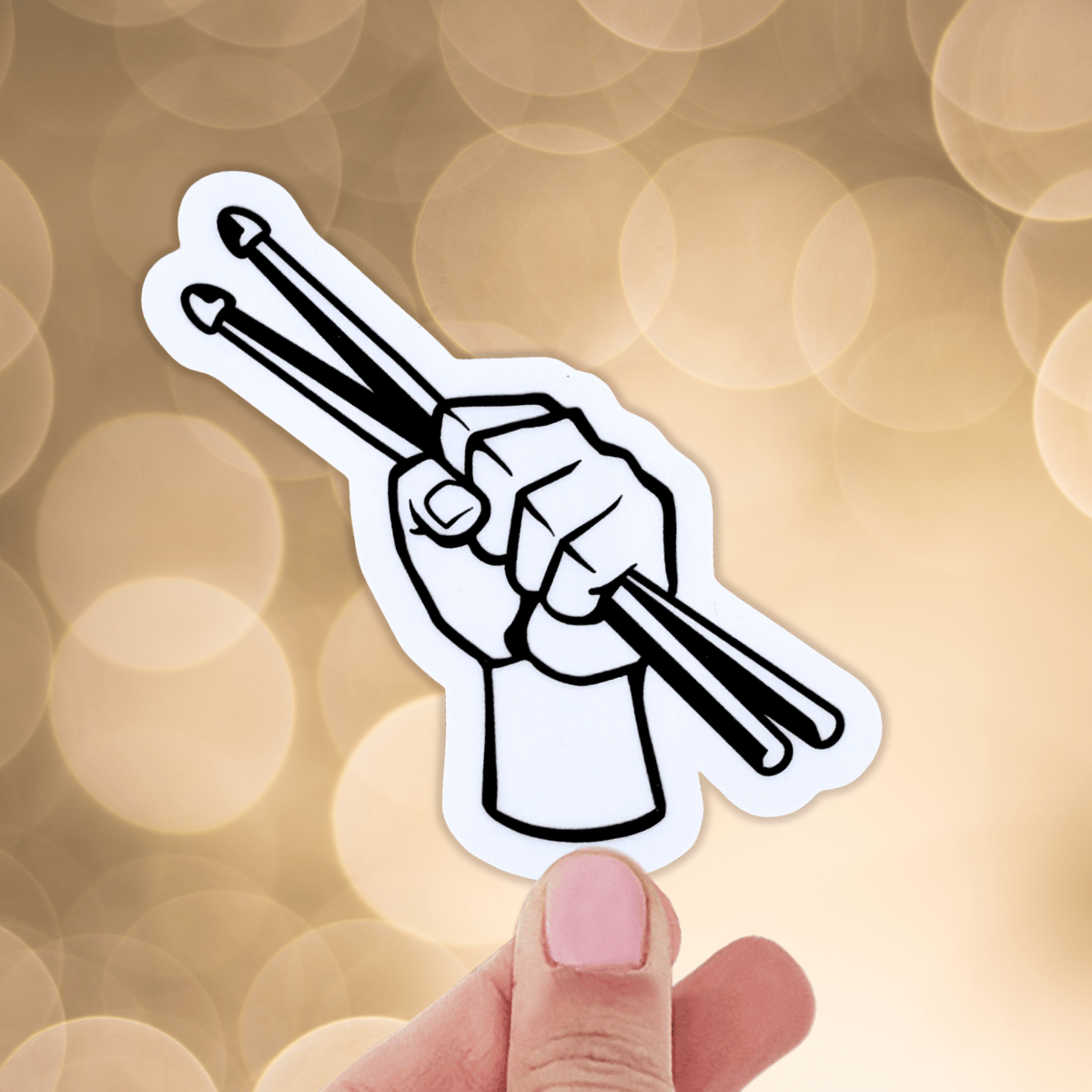 Sticker of a hand holding drumsticks against a blurred bokeh background