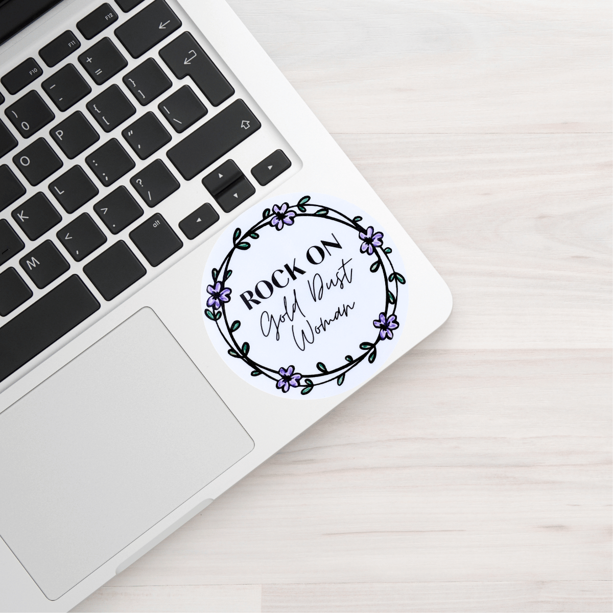 Laptop with a sticker on a wooden surface