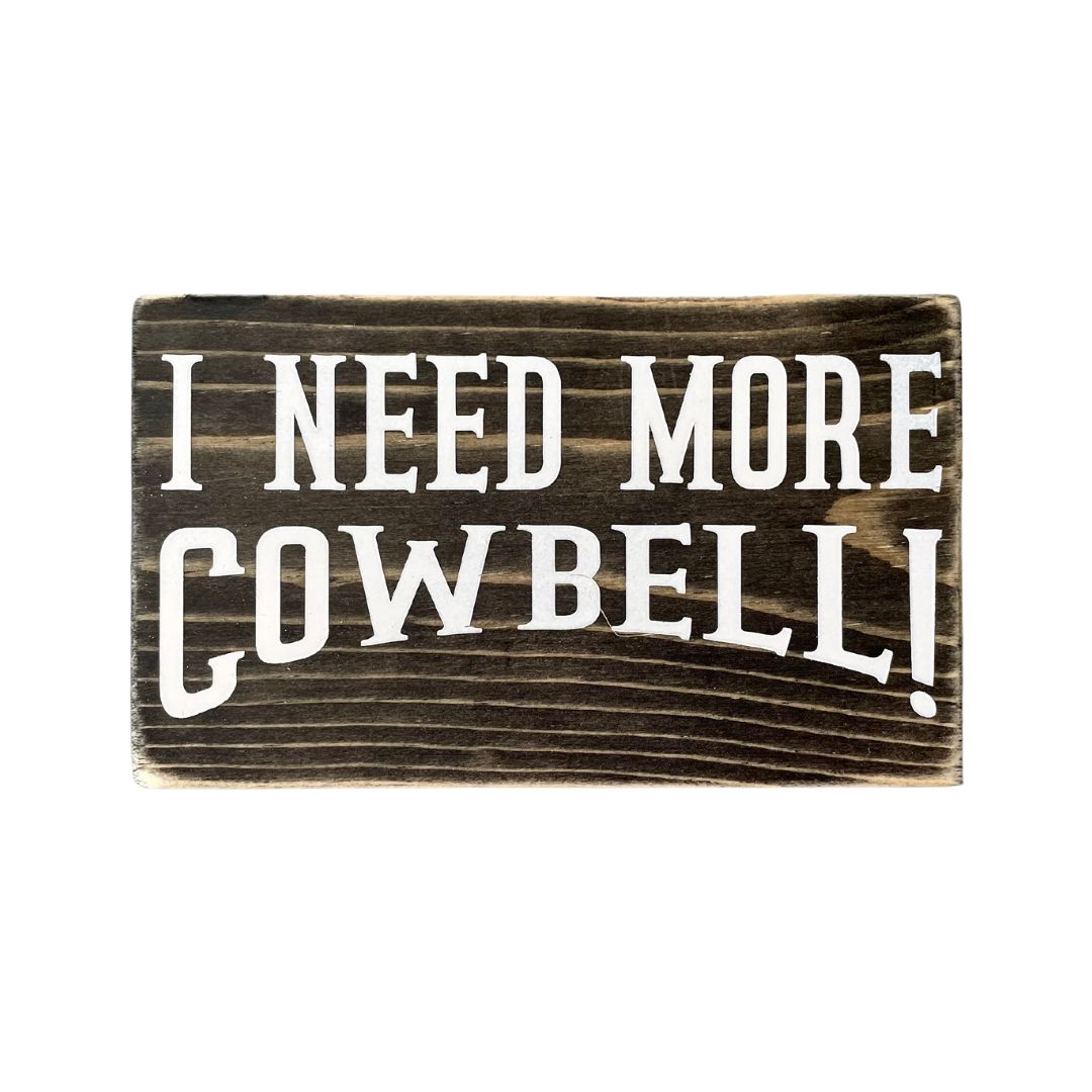 A small, black, wood sign sits on a white background.