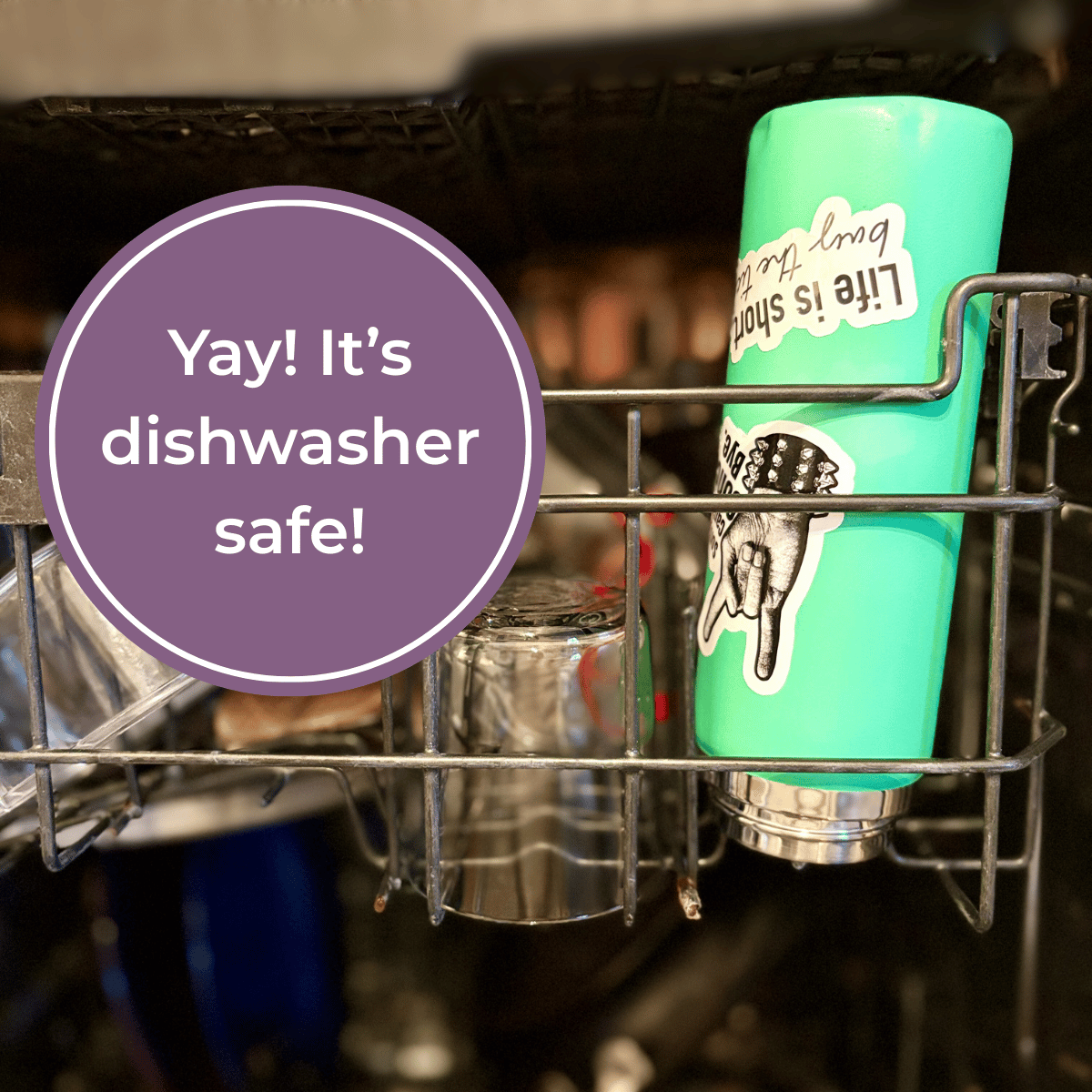Green tumbler with stickers in a dishwasher with 'Yay! It's dishwasher safe!' text overlay.