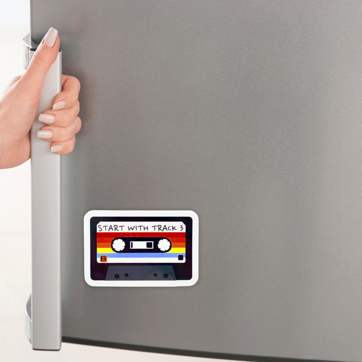 Fridge with a retro cassette tape sticker on it labeled 'Start with Track 3'.
