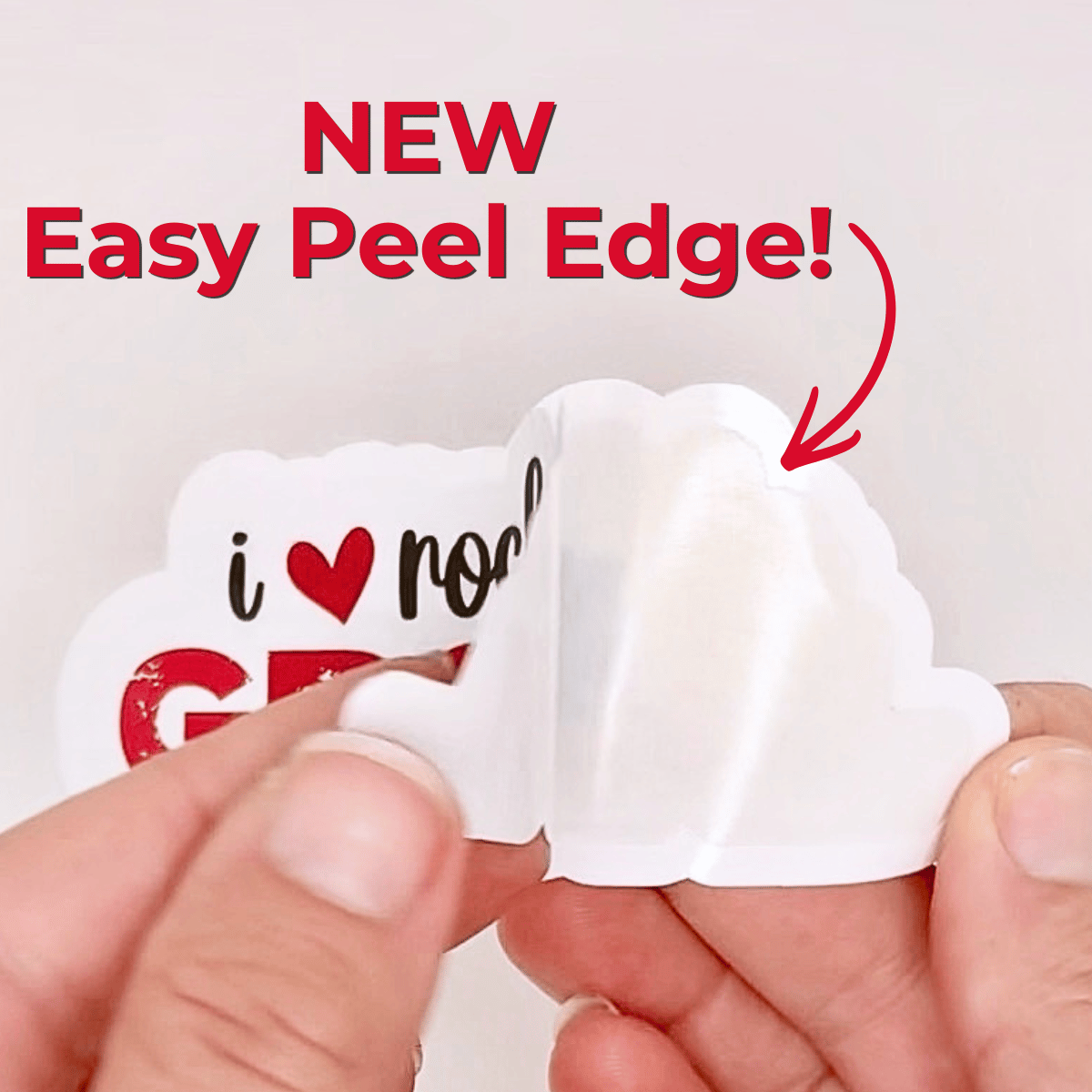 A sticker is partially peeled away from its backing showing that it has an easy-peel edge.