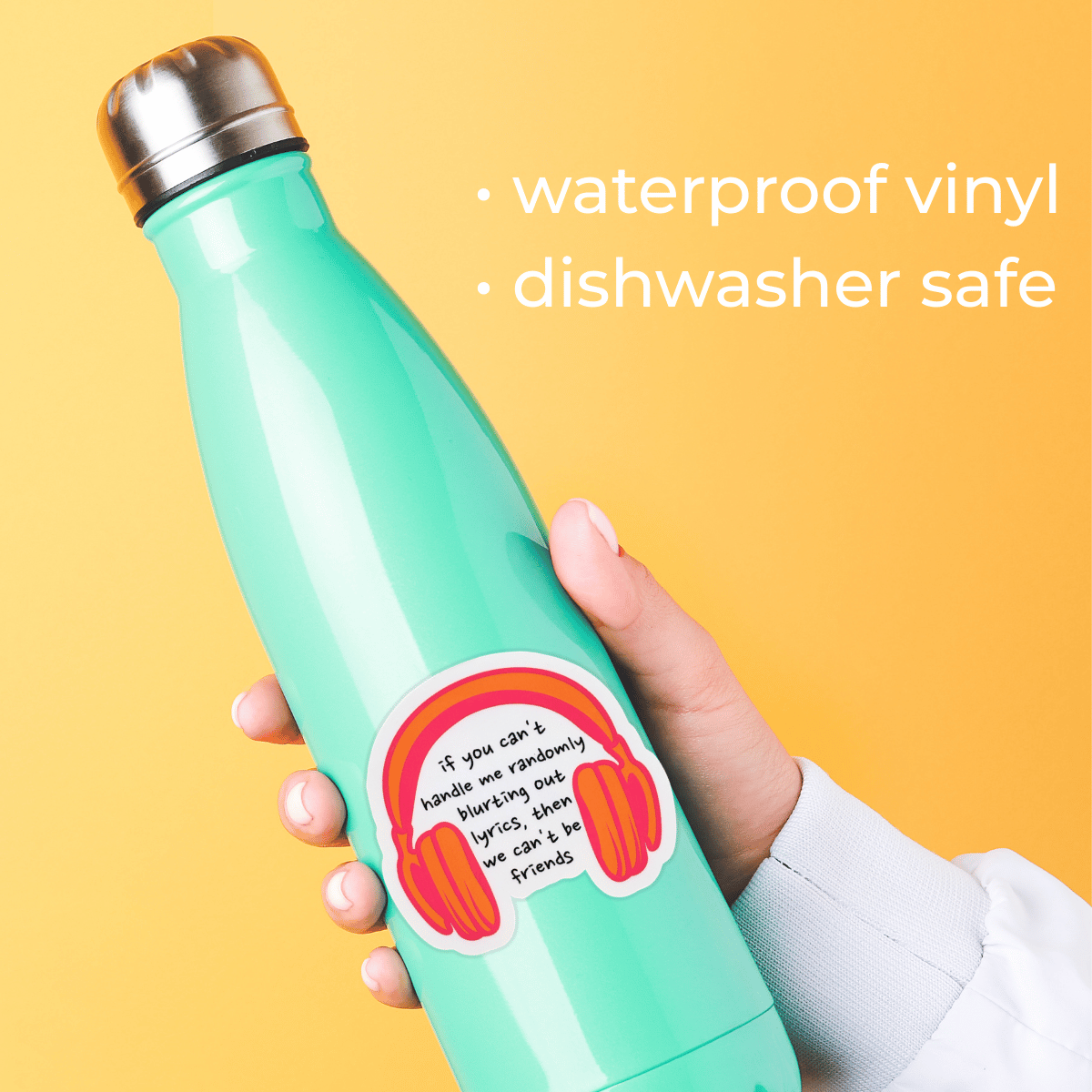 Turquoise water bottle with a colorful sticker held by a hand on a yellow background
