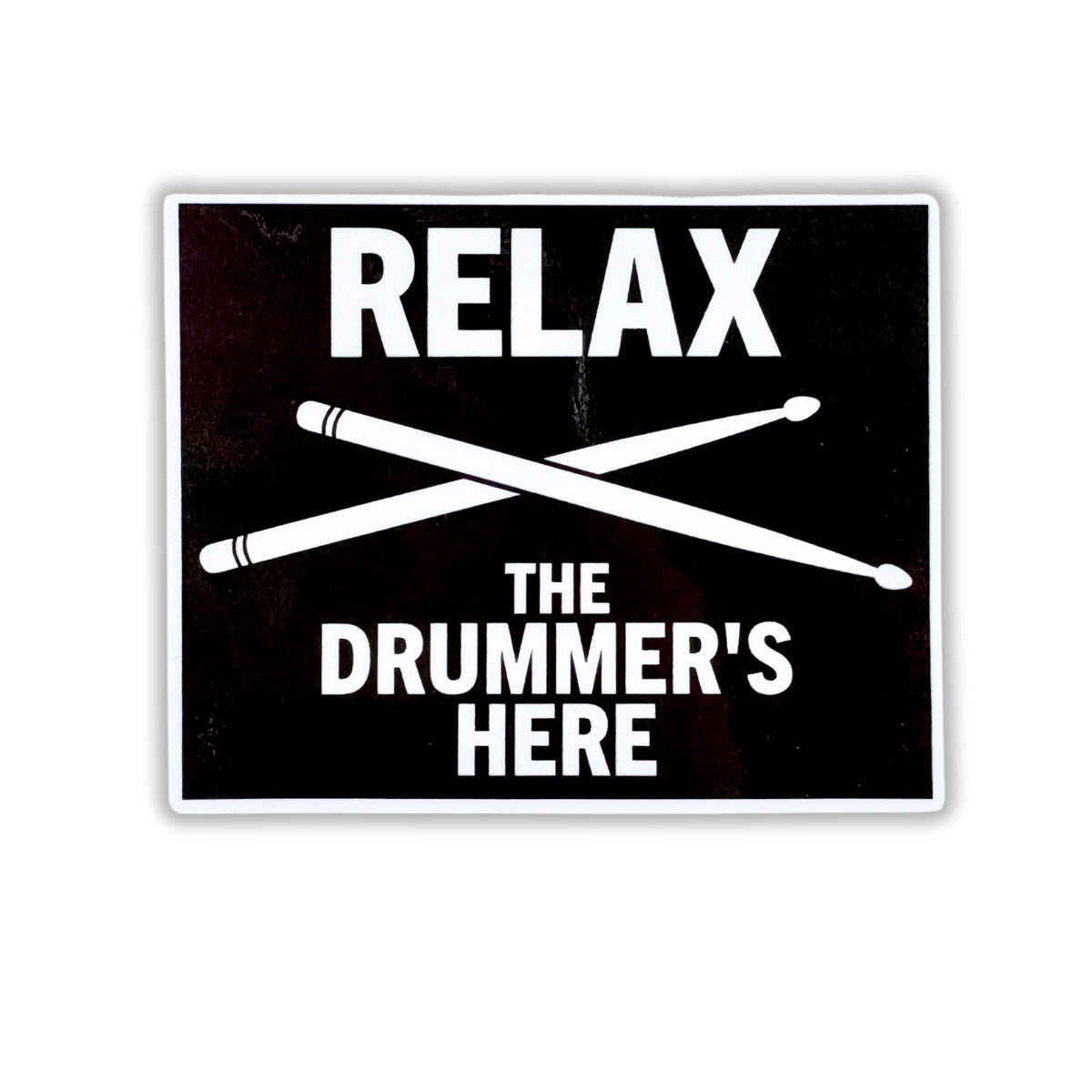 Sticker with 'Relax, the drummer's here' text and crossed drumsticks on a black background