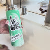 a water bottle with stickers on it is being washed in a sink