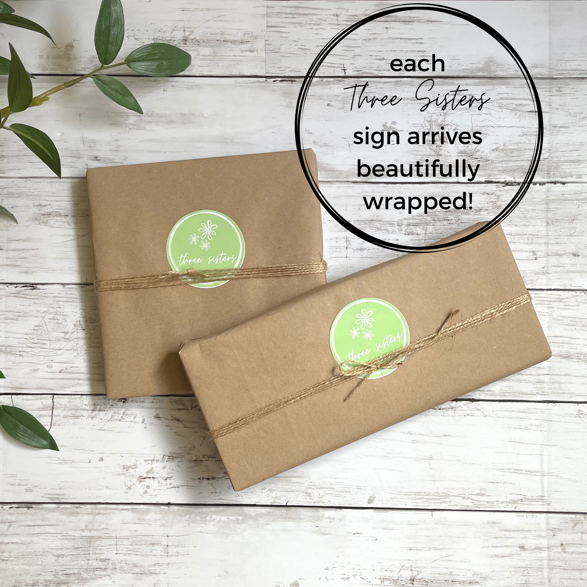 Two wood signs wrapped in brown kraft paper and tied with a twine bow. Both have a Three Sisters Studio logo sticker in the center.