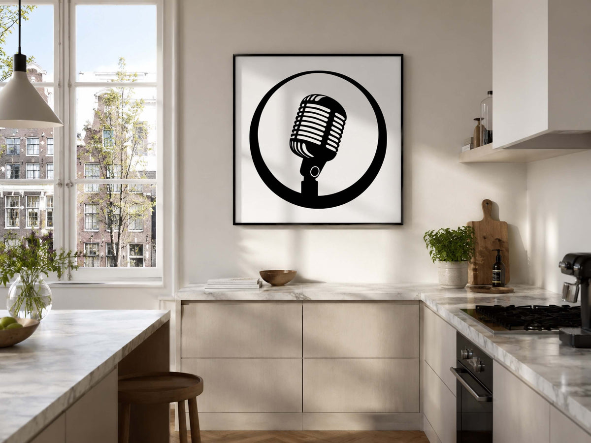 A framed black and white graphic print of a retro microphone in a circle, displayed on a kitchen wall above marble countertops.